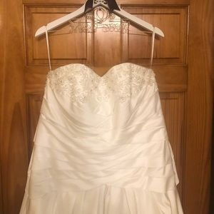 White strapless wedding gown with beading on chest area and corset back.